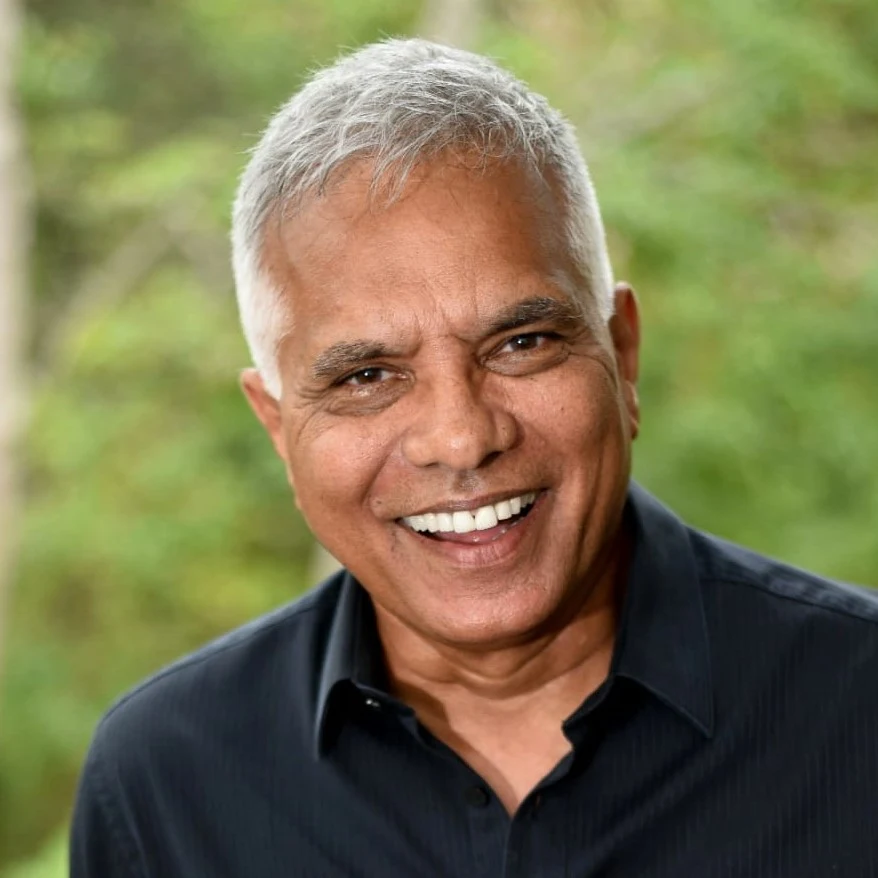 Dr Jonathan Toussaint, smiling, in a dark shirt